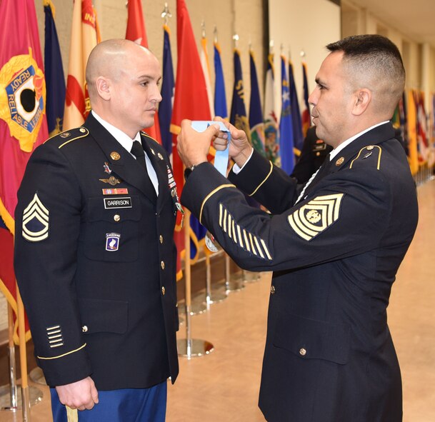 Sgt. 1st Class Jeremy Garrison receives Sergeant Audie Murphy Club medal.