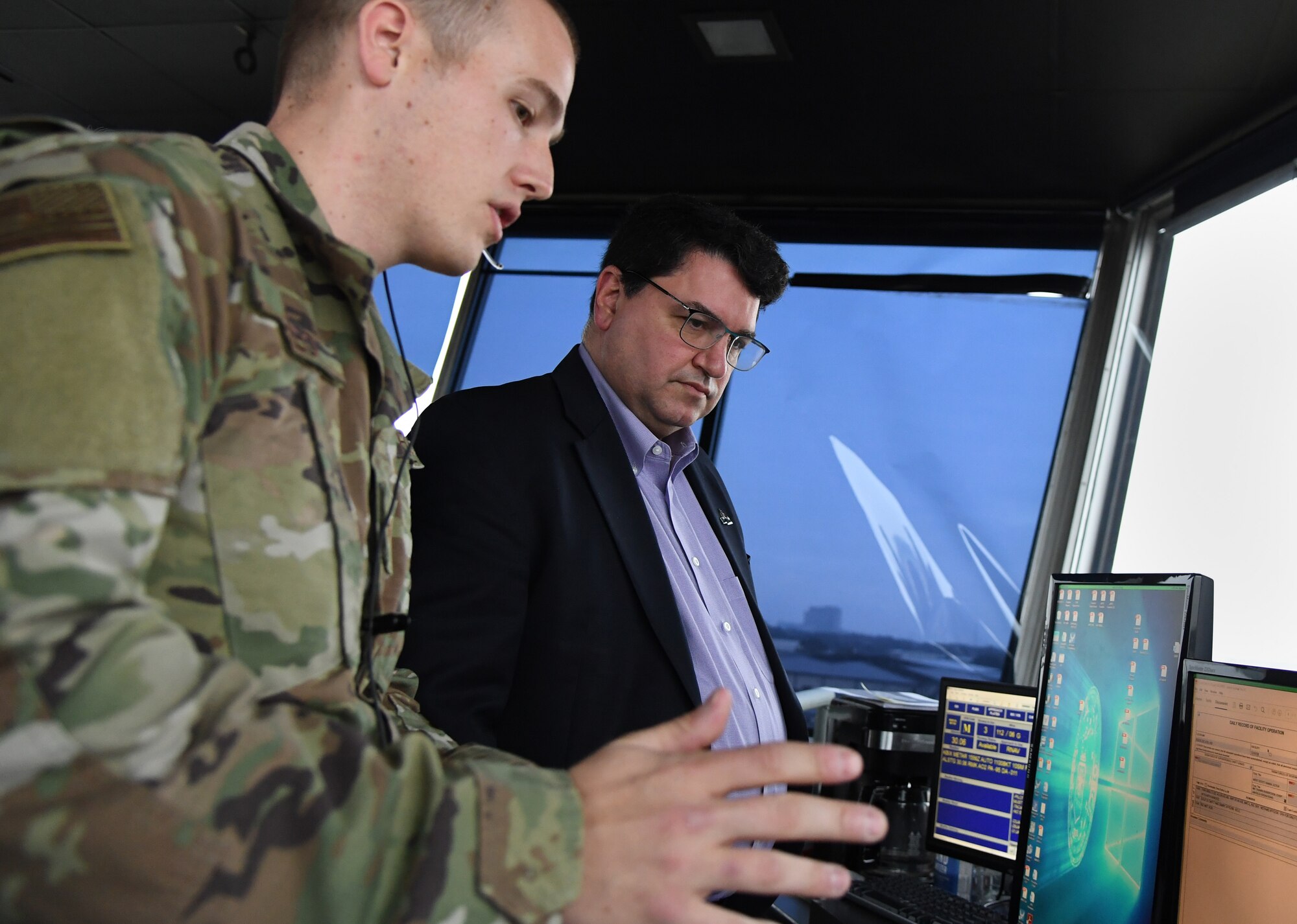 U.S. Air Force Staff Sgt. Andrew Abreo, 81st Operations Support Flight air traffic controller, reviews air traffic control tower support details to Peter Abide, Biloxi, Mississippi, city attorney, asks questions during during the airspace sustainability tour inside Cody Hall at Keesler Air Force Base, Mississippi, Jan. 23, 2019. Keesler hosted the community engagement for civic leaders to discuss Keesler's flying mission requirements in order to create processes which informs key decision makers regarding local development and to ensure compatible economic growth for the surrounding communities. (U.S. Air Force photo by Kemberly Groue)