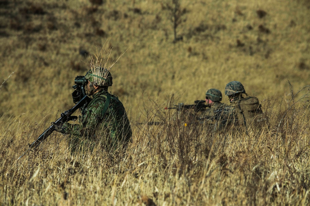 Marines provide security during a bilateral vertical assault for Exercise Forest Light Western Army at Camp Oyanohara, Kumamoto, Japan, Jan. 23.