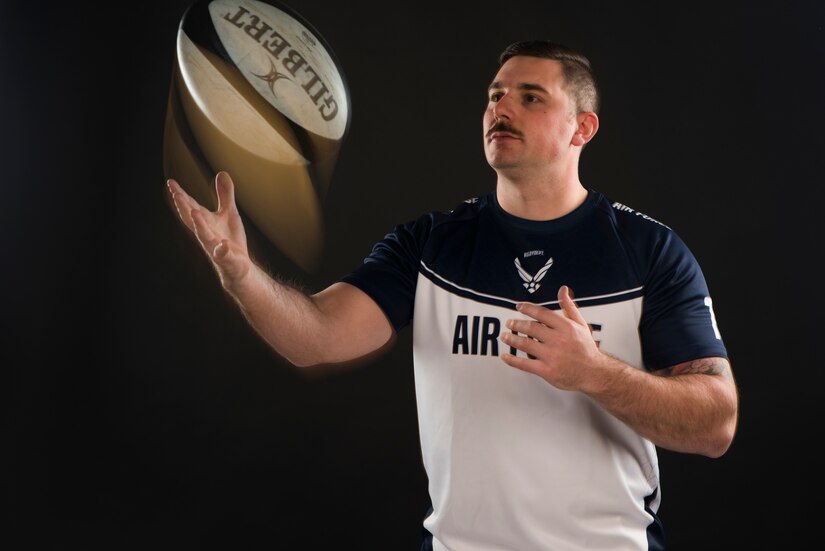 Staff Sgt. Drake Dougherty, an inbound cargo supervisor assigned to the 437th Aerial Port Squadron, poses for a photo and tosses a rugby ball Jan. 22, 2020, at Joint Base Charleston, S.C. The Air Force rugby team developed an effort that helped the team come together called the “launch pad.” It is a mindset that it takes everyone on the team to help launch their team toward success and recognizing everyone on the team plays a significant role.