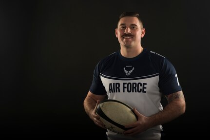 Staff Sgt. Drake Dougherty, an inbound cargo supervisor assigned to the 437th Aerial Port Squadron, poses for a photo with his rugby ball Jan. 22, 2020, at Joint Base Charleston, S.C. Dougherty has been playing on the Air Force rugby team for one year, but has been playing rugby for 11 years total. The Air Force rugby team helped Dougherty when he was going through a challenging time in his life by promoting positive thinking, teamwork and finding motivation.  Dougherty also plays for a local rugby team called the Charleston Outlaws