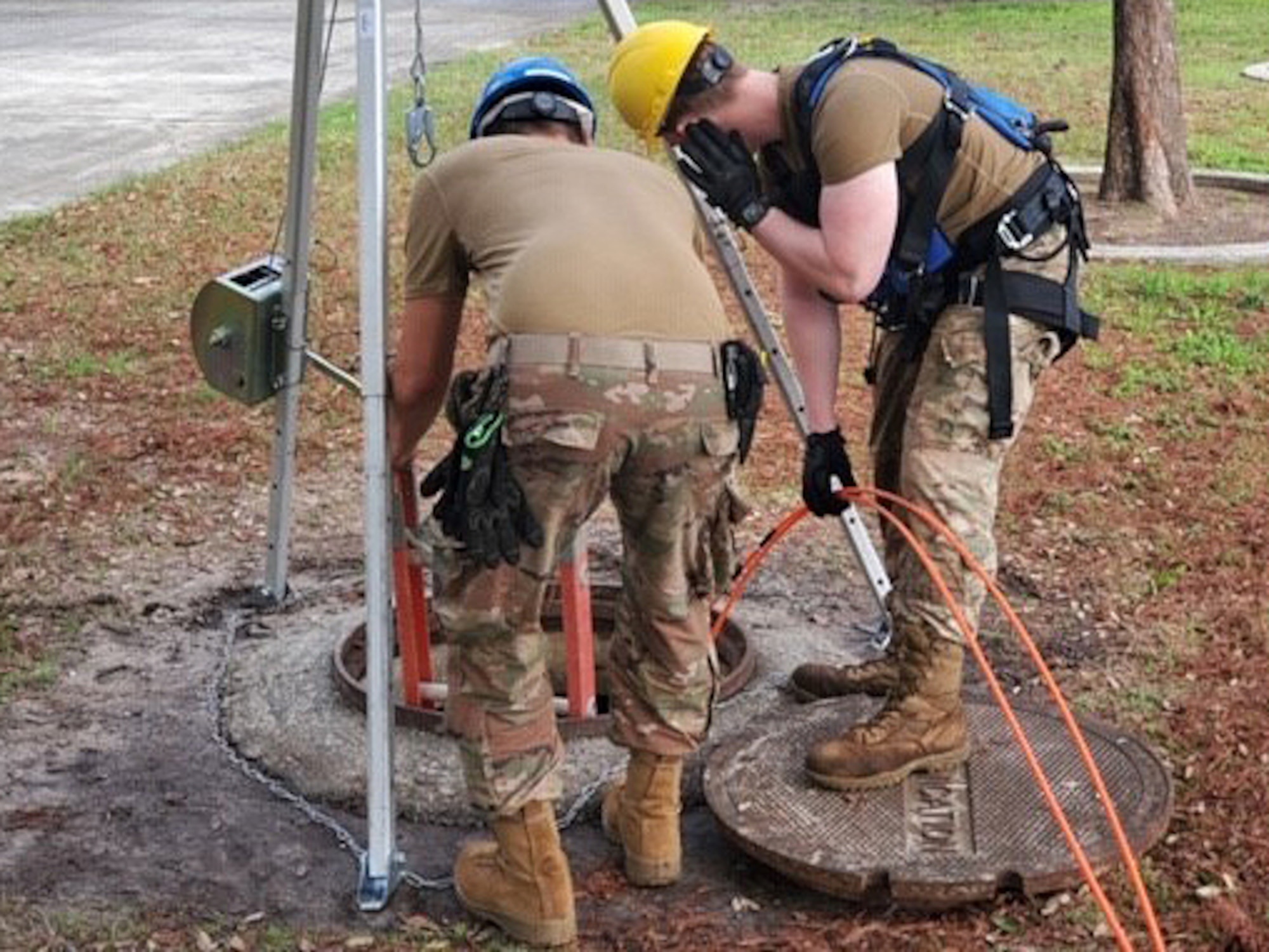 U.S. Air Force Senior Airman Jacob Melville and Airman 1st Class Hunter Benson, 85th Engineering Installation Squadron cable and antenna technicians, lower a cable for installation at Keesler Air Force Base, Mississippi, Jan. 14, 2020. Keesler is the first in the Air Force to use the new blown fiber installation. Blown fiber installation is a new cable installing process that cuts the timeline on installation from seven to 10 days to three days. (Courtesy photo by Tech. Sgt. Bryan Williams)