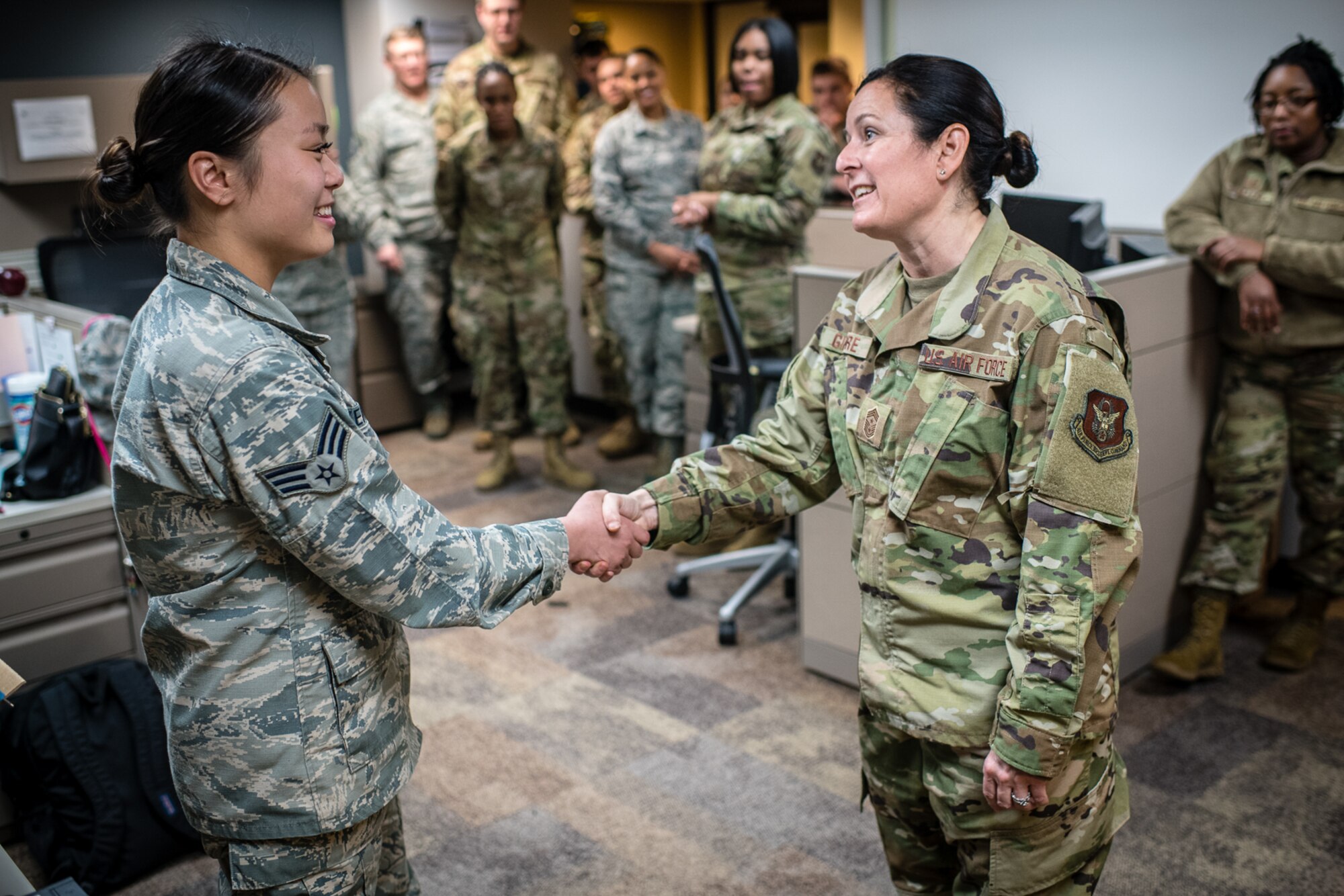 U.S. Air Force Citizen Airman, Senior Airman Kathryn N. Baskerville, 932nd Force Support Squadron, customer support technician  receives a Wing coin from 932nd Airlift Wing Command Chief, Barbara Gilmore for overall excellence in service and Baskervilles's recent graduation from Airmen Leadership School, Jan. 10, 2020, Scott Air Force Base, Illinois. (U.S. Air Force photo by Christopher Parr)