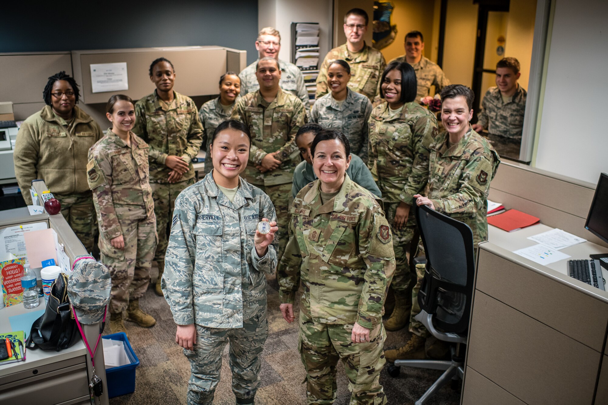 U.S. Air Force Citizen Airman, Senior Airman Kathryn N. Baskerville, 932nd Force Support Squadron, customer support technician  receives a Wing coin from 932nd Airlift Wing Command Chief, Barbara Gilmore for overall excellence in service and Baskervilles's recent graduation from Airmen Leadership School, Jan. 10, 2020, Scott Air Force Base, Illinois. (U.S. Air Force photo by Christopher Parr)