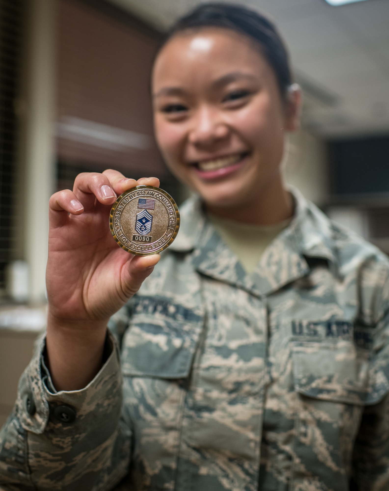 U.S. Air Force Citizen Airman, Senior Airman Kathryn N. Baskerville, 932nd Force Support Squadron, customer support technician  receives a Wing coin from 932nd Airlift Wing Command Chief, Barbara Gilmore for overall excellence in service and Baskervilles's recent graduation from Airmen Leadership School, Jan. 10, 2020, Scott Air Force Base, Illinois. (U.S. Air Force photo by Christopher Parr)