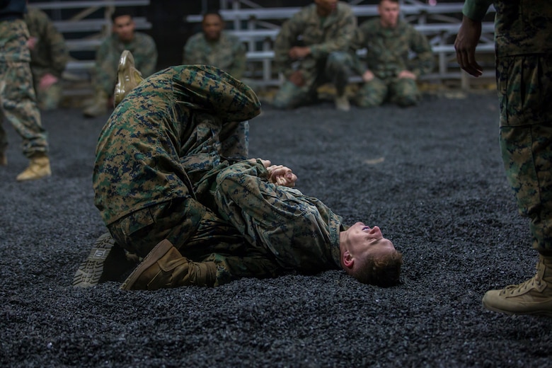 U.S. Marines assigned to Headquarters and Headquarters Squadron and Marine Aircraft Group 13 Corporals courses compete against each other in a grappling match on Marine Corps Air Station Yuma, Jan. 23, 2019. The match was conducted as the Marines morning physical training, as well as an opportunity to boost morale and comradery during a friendly competition. (U.S. Marine Corps photo by Lance Cpl John Hall)