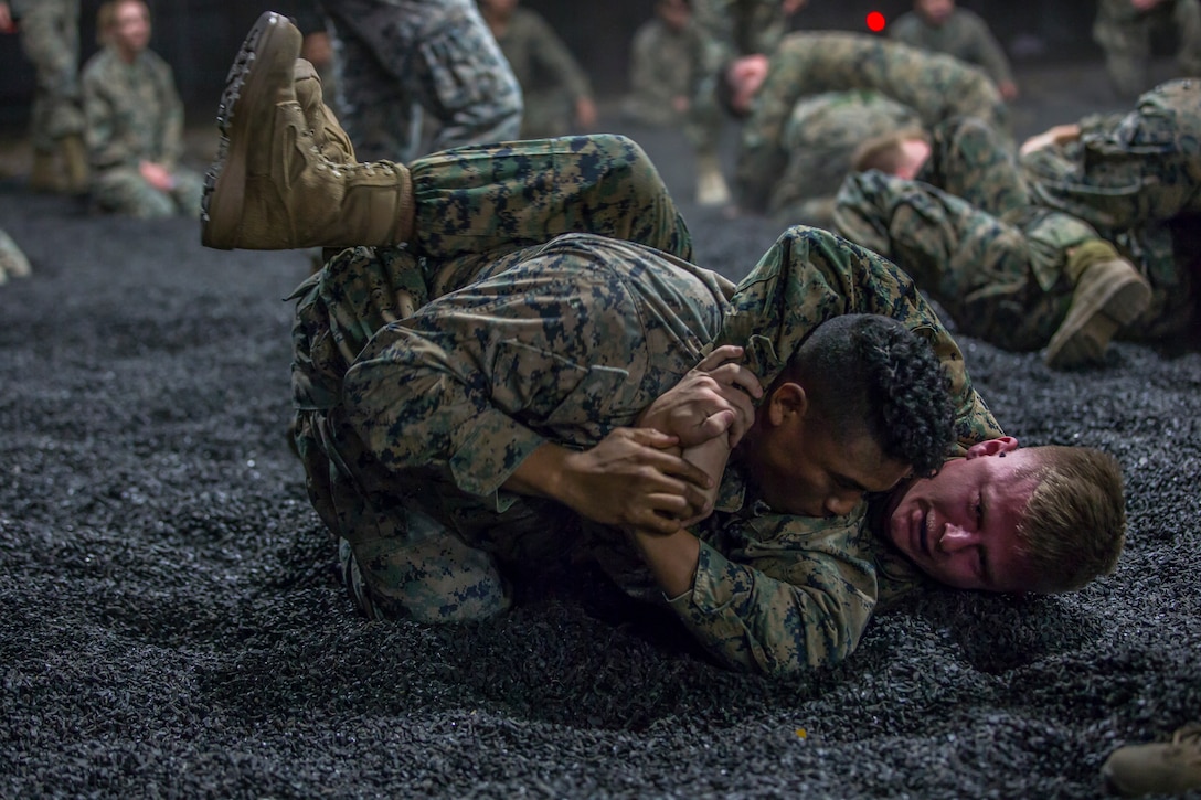 U.S. Marines assigned to Headquarters and Headquarters Squadron and Marine Aircraft Group 13 Corporals courses compete against each other in a grappling match on Marine Corps Air Station Yuma, Jan. 23, 2019. The match was conducted as the Marines morning physical training, as well as an opportunity to boost morale and comradery during a friendly competition. (U.S. Marine Corps photo by Lance Cpl John Hall)