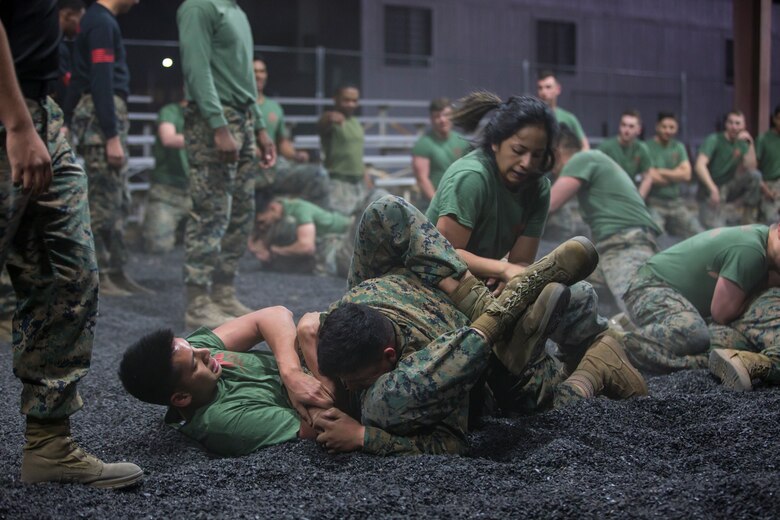 U.S. Marines assigned to Headquarters and Headquarters Squadron and Marine Aircraft Group 13 Corporals courses compete against each other in a grappling match on Marine Corps Air Station Yuma, Jan. 23, 2019. The match was conducted as the Marines morning physical training, as well as an opportunity to boost morale and comradery during a friendly competition. (U.S. Marine Corps photo by Lance Cpl John Hall)