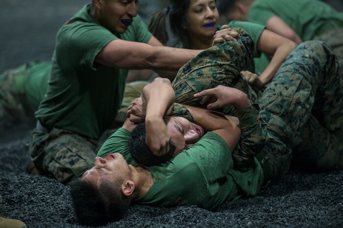 U.S. Marines assigned to Headquarters and Headquarters Squadron and Marine Aircraft Group 13 Corporals courses compete against each other in a grappling match on Marine Corps Air Station Yuma, Jan. 23, 2019. The match was conducted as the Marines morning physical training, as well as an opportunity to boost morale and comradery during a friendly competition. (U.S. Marine Corps photo by Lance Cpl John Hall)