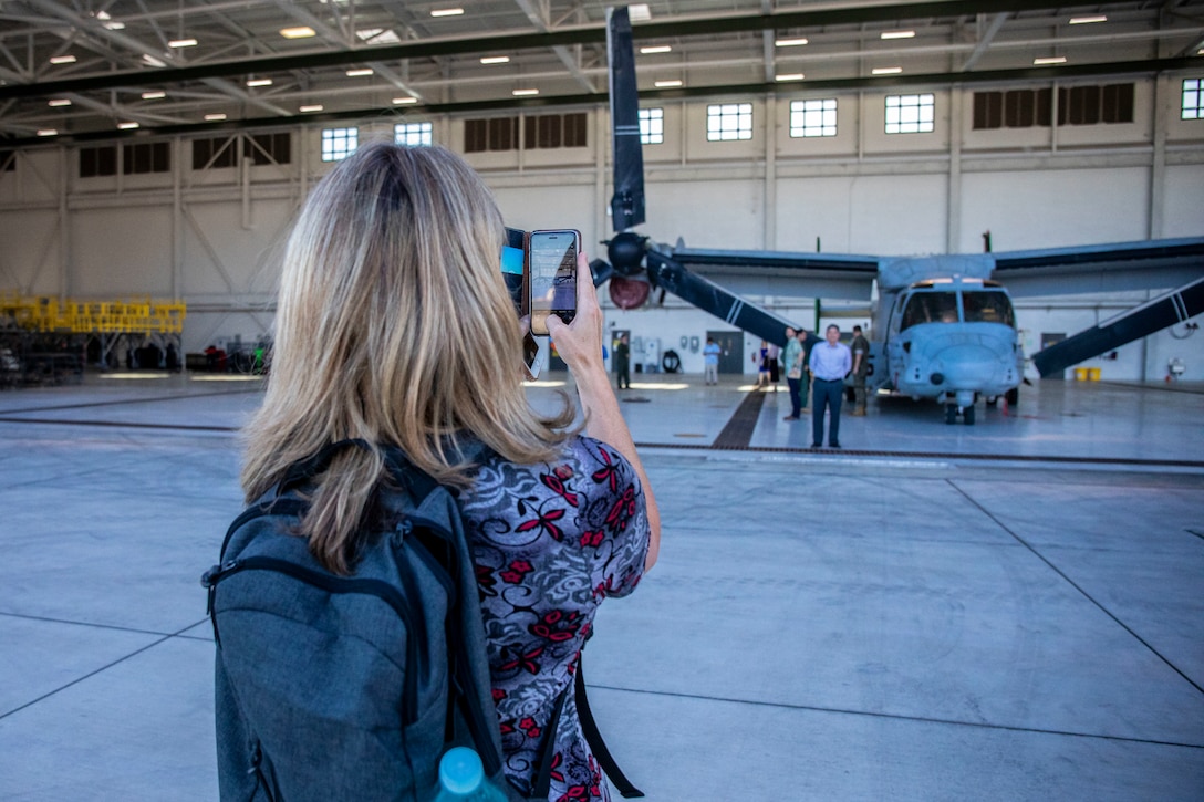 Nicola Macaulay, a professor at Massey University, Palmerston North, New Zealand, takes a picture of an MV-22B Osprey with Marine Medium Tiltrotor Squadron (VMM) 363 during a tour of Marine Corps Base Hawaii (MCBH), Dec. 11, 2019. New Zealand professors toured MCBH to learn about the Hawaii Marine Air-Ground Task Force and the base's mission in the U.S. Indo-Pacific region. The tour included a static display of amphibious assault vehicles, MV-22B Ospreys with VMM-363, and a flight simulation of an Osprey. (U.S. Marine Corps photo by Cpl. Matthew Kirk)