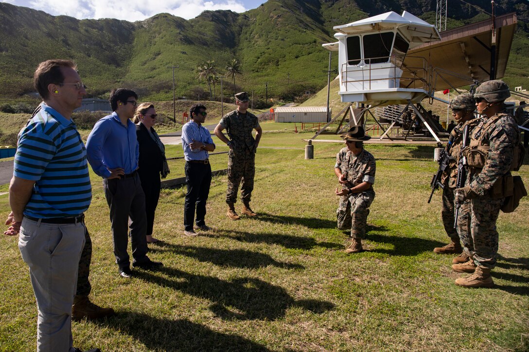 Jason Steinbaum, left, Democratic staff director, House committee on foreign affairs, Ryan Uyehara, Legislative assistant for Congressman Ami Bera (D-CA), U.S. Navy Capt. Kati Hill, deputy director, House Navy liaison, Sajit Gandhi, House committee on foreign affairs, listen to a brief given by U.S. Marine Corps Chief Warrant Officer 3 Harry Taylor, range officer, Ulupa’u Crater, Marine Corps Base Hawaii (MCBH), during a visit, MCBH, Jan. 21, 2019. MCBH hosted Gandhi, Steinbaum, Uyehara, and Hill to provide them the opportunity to see a training event and interact with service members in the field, explaining the importance of the ranges, Marine Corps training, the bases relationship with the community and other services, and the preservation of historical and cultural resources. (U.S. Marine Corps Photo by Lance Cpl. Samantha Sanchez)