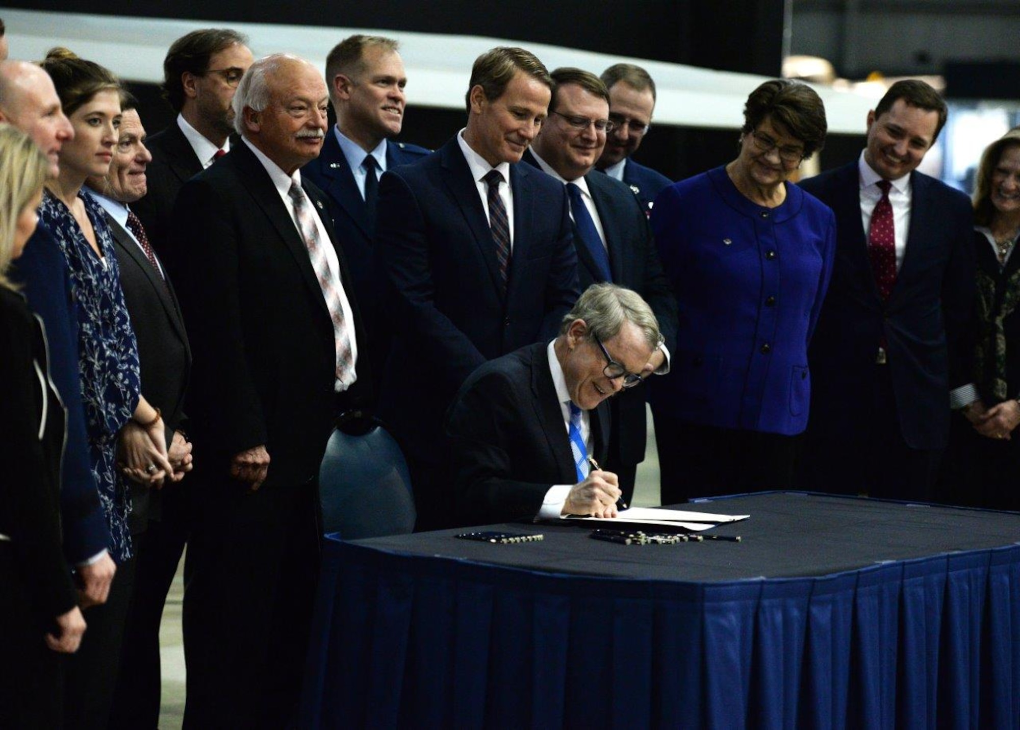 Ohio Governor Mike DeWine signs Senate Bill 7 into law at the National Museum of the United States Air Force, Wright-Patterson Air Force Base, Ohio, Jan. 27, 2020. The bill mandates Ohio agencies to issue licenses or certificates to qualifying military members and their spouses. (U.S. Air Force photo by Wesley Farnsworth)