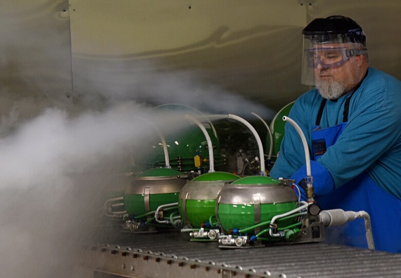 Bradley Lange, an instrument mechanic with the 550th Commodities Maintenance Squadron, fills LOX converters in the Flow Room of the Oxygen Shop. A final functionality test the two testers perform in this shop consist of performing weights and filling the LOX converters, capacitance checks, and flow tests, a two-day process  before the converters are sent back to the customers. (U.S. Air Force photo/Kelly White)