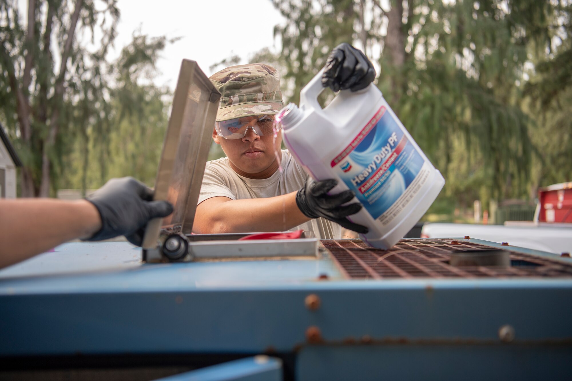 U.S. Air Force Staff Sgt. Gabriel Carias, 624th Civil Engineer Squadron electrical power production craftsman, pours antifreeze into an electrical generator at Bellows Air Force Station, Hawaii, Jan. 25, 2020.