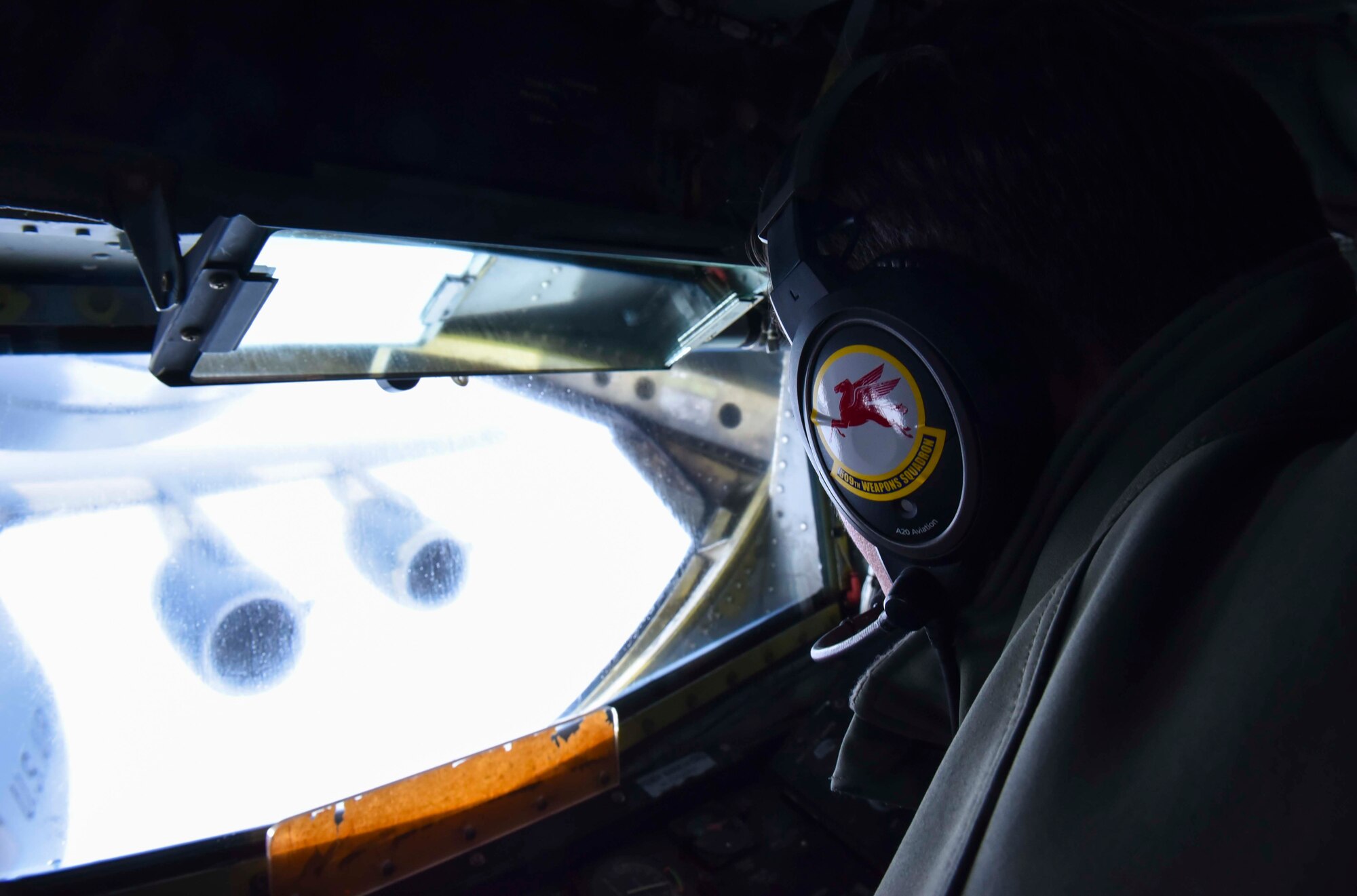 U.S. Air Force Staff Sgt. Robert “Buck” Medeiros, 509th Weapons Squadron advanced instructor course instructor, performs aerial refueling on a C-17 Globemaster from McChord Air Force Base, Washington, over the Inland Northwest Jan. 22, 2020. Training flights help ensure that crews are able to perform aerial refueling without needing communication with the aircraft receiving fuel. (U.S. Air Force photo by Airman 1st Class Kiaundra Miller)