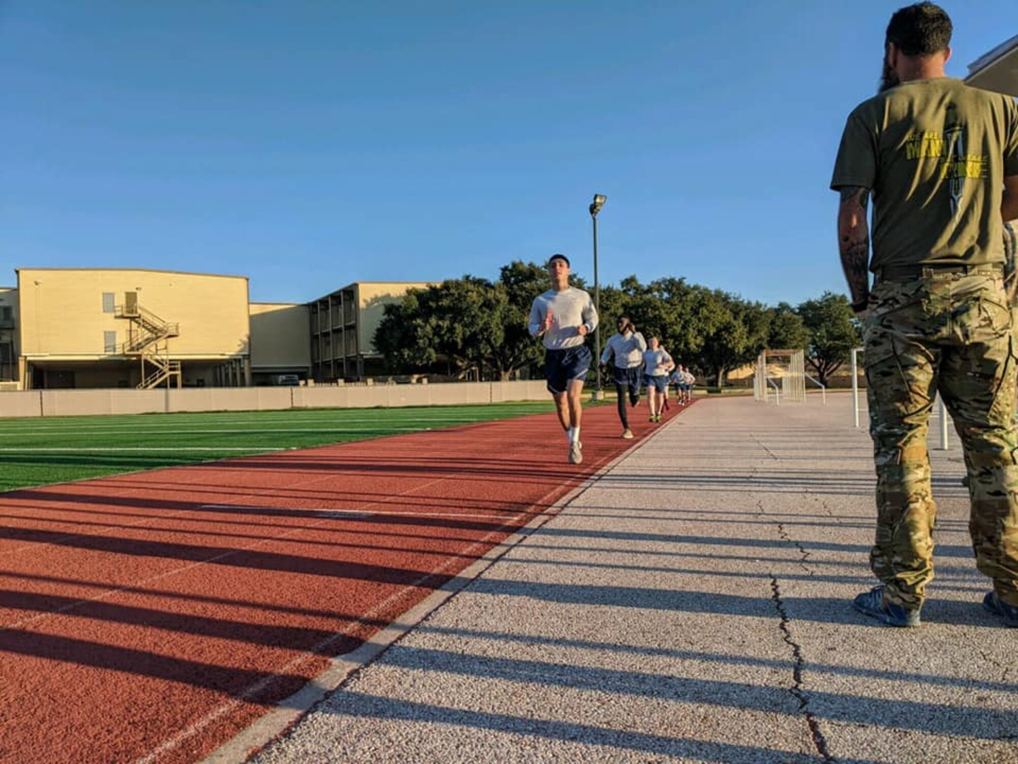 Security Forces Airmen take part in the run portion of a physical fitness test as the opening day of the Air Education and Training Command Defender Challenge team tryout at Joint Base San Antonio-Lackland, Texas, Jan. 27, 2020. The five-day selection camp includes a physical fitness test, M-9 and M-4 weapons firing, the alpha warrior obstacle course, a ruck march and also includes a military working dog tryout as well.