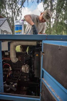 U.S. Air Force Staff Sgt. Gabriel Carias, 624th Civil Engineer Squadron electrical power production craftsman, prepares to put antifreeze into an electrical generator at Bellows Air Force Station, Hawaii, Jan. 25, 2020.