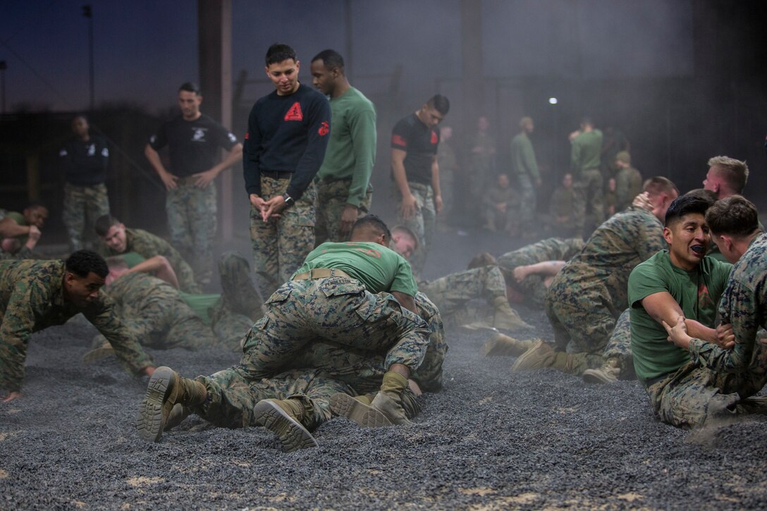 U.S. Marines assigned to Headquarters and Headquarters Squadron and Marine Aircraft Group 13 Corporals courses compete against each other in a grappling match on Marine Corps Air Station Yuma, Jan. 23, 2019. The match was conducted as the Marines morning physical training, as well as an opportunity to boost morale and comradery during a friendly competition. (U.S. Marine Corps photo by Lance Cpl John Hall)