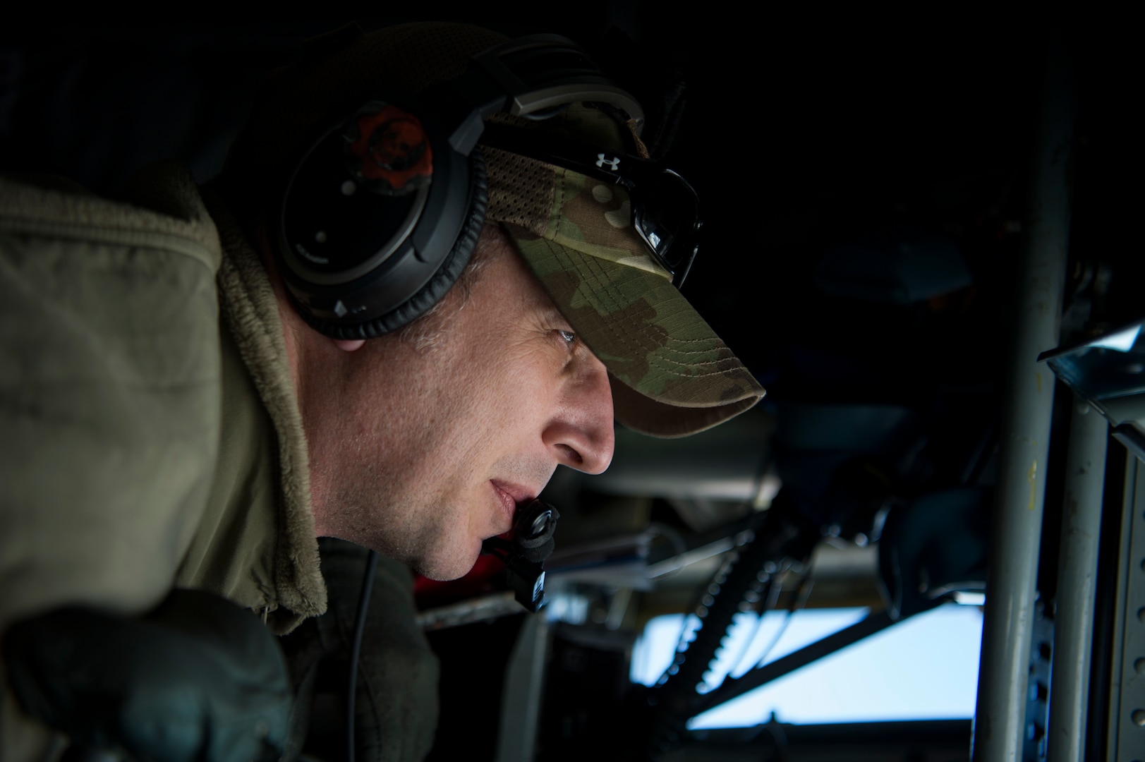 A U.S. Air Force in-flight refueling specialist assigned to the 28th Expeditionary Air Refueling Squadron scans the horizon from a KC-135 Stratotanker over Afghanistan, Jan. 14, 2020.