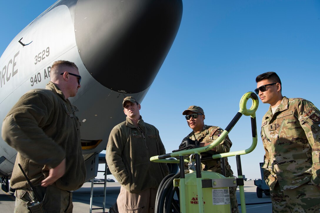 U.S. Air Force aircrew members assigned to the 28th Expeditionary Air Refueling Squadron discuss details of a KC-135 Stratotanker preflight inspection with a U.S. Air Force crew chief assigned to the 385th Expeditionary Aircraft Maintenance Squadron, left, at Al Udeid Air Base, Qatar, Jan. 14, 2020.