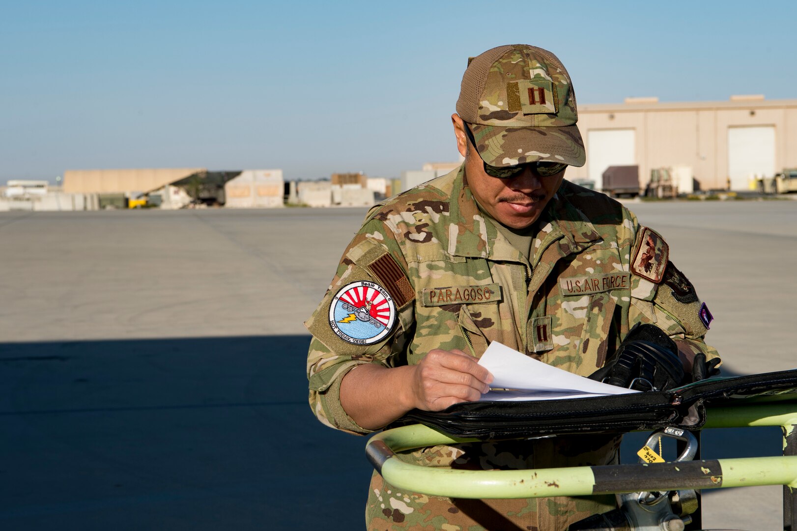 U.S. Air Force pilot assigned to the 28th Expeditionary Air Refueling Squadron reviews documents before conducting a preflight inspection on a KC-135 Stratotanker at Al Udeid Air Base, Qatar, Jan. 14, 2020.