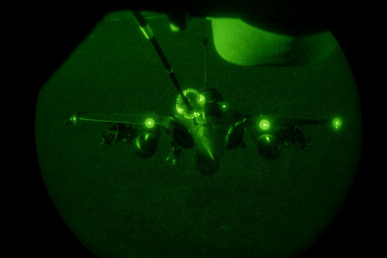 A U.S. Air Force KC-10 Extender boom operator with the 908th Expeditionary Air Refueling Squadron conducts an aerial refueling with a French Air Force Dassault Rafale fighter aircraft in support of Operation Inherent Resolve, Jan. 11, 2020.