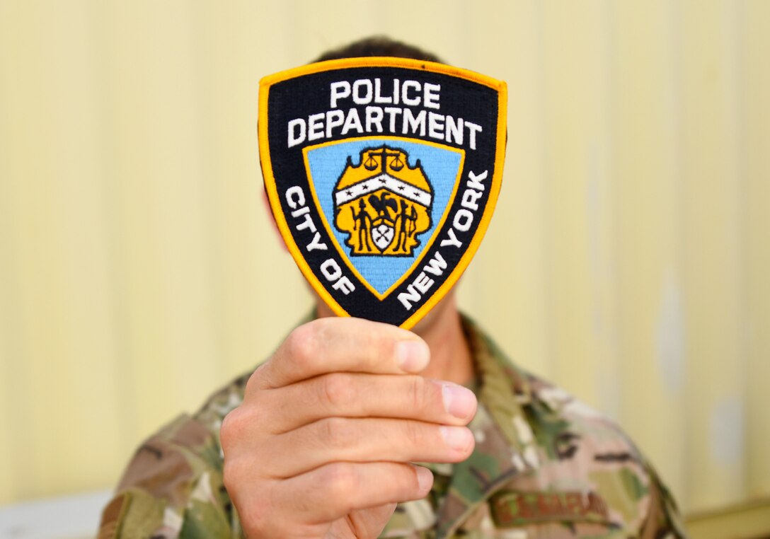 U.S. Air Force Tech. Sgt. Bill Reed, 82nd Expeditionary Rescue Squadron Det. 1 Tactical Air Control Party joint terminal attack controller, holds his New York City Police Department patch at Camp Lemonnier, Djibouti, Nov. 20, 2019. When he is not deployed, Reed is a detective in the NYPD’s Emergency Services Unit. (U.S. Air Force photo by Staff Sgt. Alex Fox Echols III)