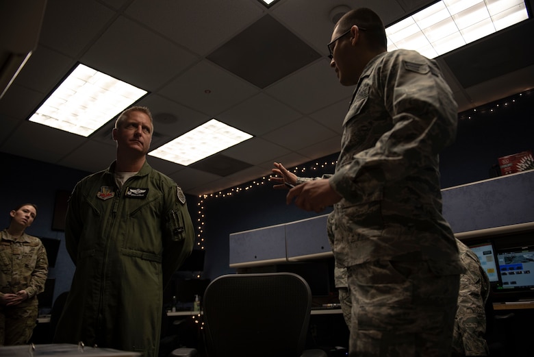 U.S. Air Force Senior Airman Alan Garcia, 325th Fighter Wing Tyndall Command Center junior emergency actions controller, right, briefs U.S. Air Force Col. Brain Laidlaw, 325th Fighter Wing commander, left, at Tyndall Air Force Base, Florida, Jan. 24, 2020. Garcia arrived on station in May 2019 and has provided ideas for improvement and was instrumental in unit training.   (U.S. Air Force photo by Staff Sgt. Magen M. Reeves)