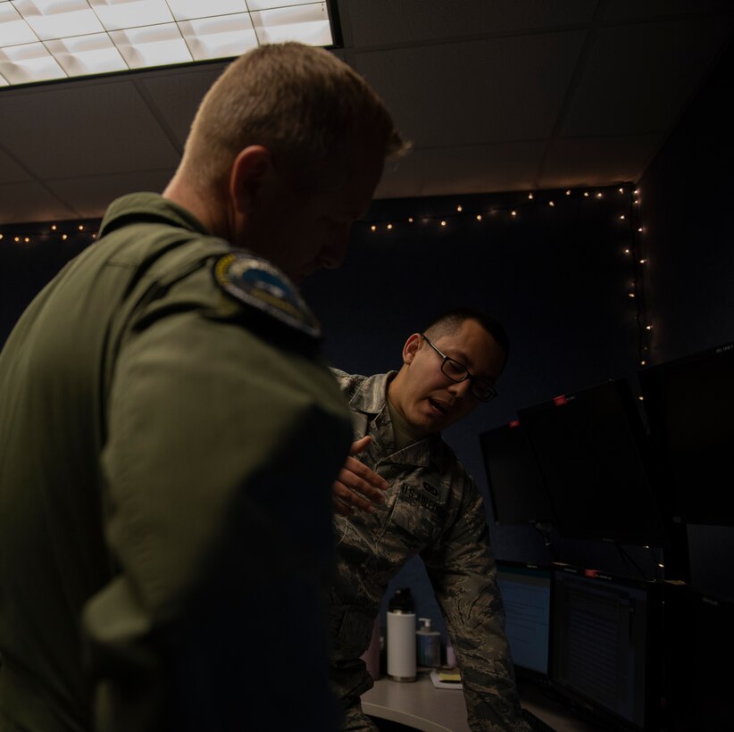 U.S. Air Force Senior Airman Alan Garcia, 325th Fighter Wing Tyndall Command Center junior emergency actions controller, right, briefs U.S. Air Force Col. Brain Laidlaw, 325th Fighter Wing commander, left, at Tyndall Air Force Base, Florida, Jan. 24, 2020. Garcia was selected to participate in the wing's Airman Shadow program in which the commander visits units across the base once a month for immersion tours. (U.S. Air Force photo by Staff Sgt. Magen M. Reeves)