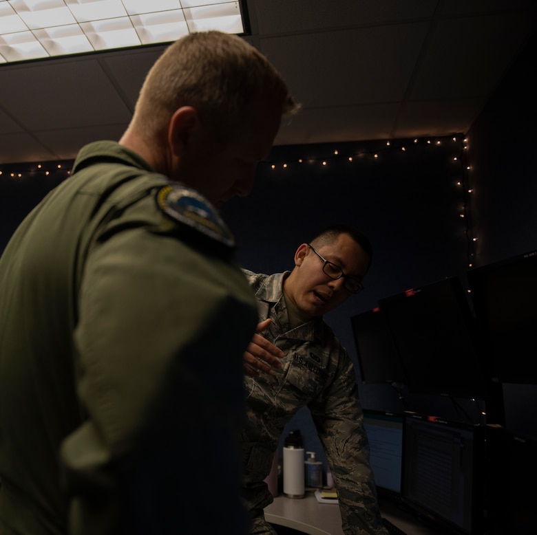 U.S. Air Force Senior Airman Alan Garcia, 325th Fighter Wing Tyndall Command Center junior emergency actions controller, right, briefs U.S. Air Force Col. Brain Laidlaw, 325th Fighter Wing commander, left, at Tyndall Air Force Base, Florida, Jan. 24, 2020. Garcia was selected to participate in the wing's Airman Shadow program in which the commander visits units across the base once a month for immersion tours. (U.S. Air Force photo by Staff Sgt. Magen M. Reeves)