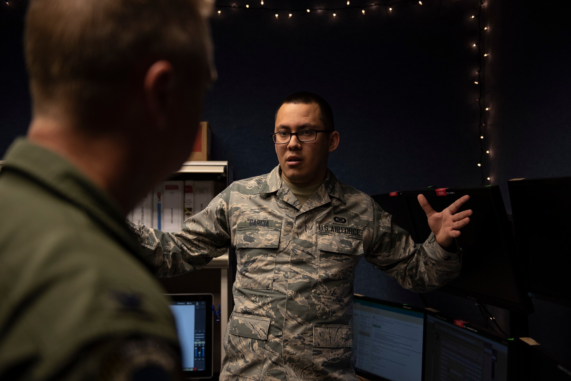 U.S. Air Force Senior Airman Alan Garcia, 325th Fighter Wing Tyndall Command Center junior emergency actions controller, briefs U.S. Col. Brain Laidlaw, 325th FW commander, on emergency action procedures at Tyndall Air Force Base, Florida, Jan. 24, 2020. Garcia  and his team receive, process, and disseminate emergency action, anti-terrorism, and force protection messages. (U.S. Air Force photo by Staff Sgt. Magen M. Reeves)
