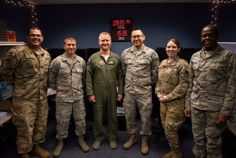 U.S. Air Force Col. Brain Laidlaw, 325th Fighter Wing commander, center, poses for a photo with members of the Tyndall Command Center at Tyndall Air Force Base, Florida, Jan. 24, 2020. The Tyndall Command Center is the command and control focal point for the wing commander and base agencies during wartime, contingency, emergency management operations and natural disasters. (U.S. Air Force photo by Staff Sgt. Magen M. Reeves)