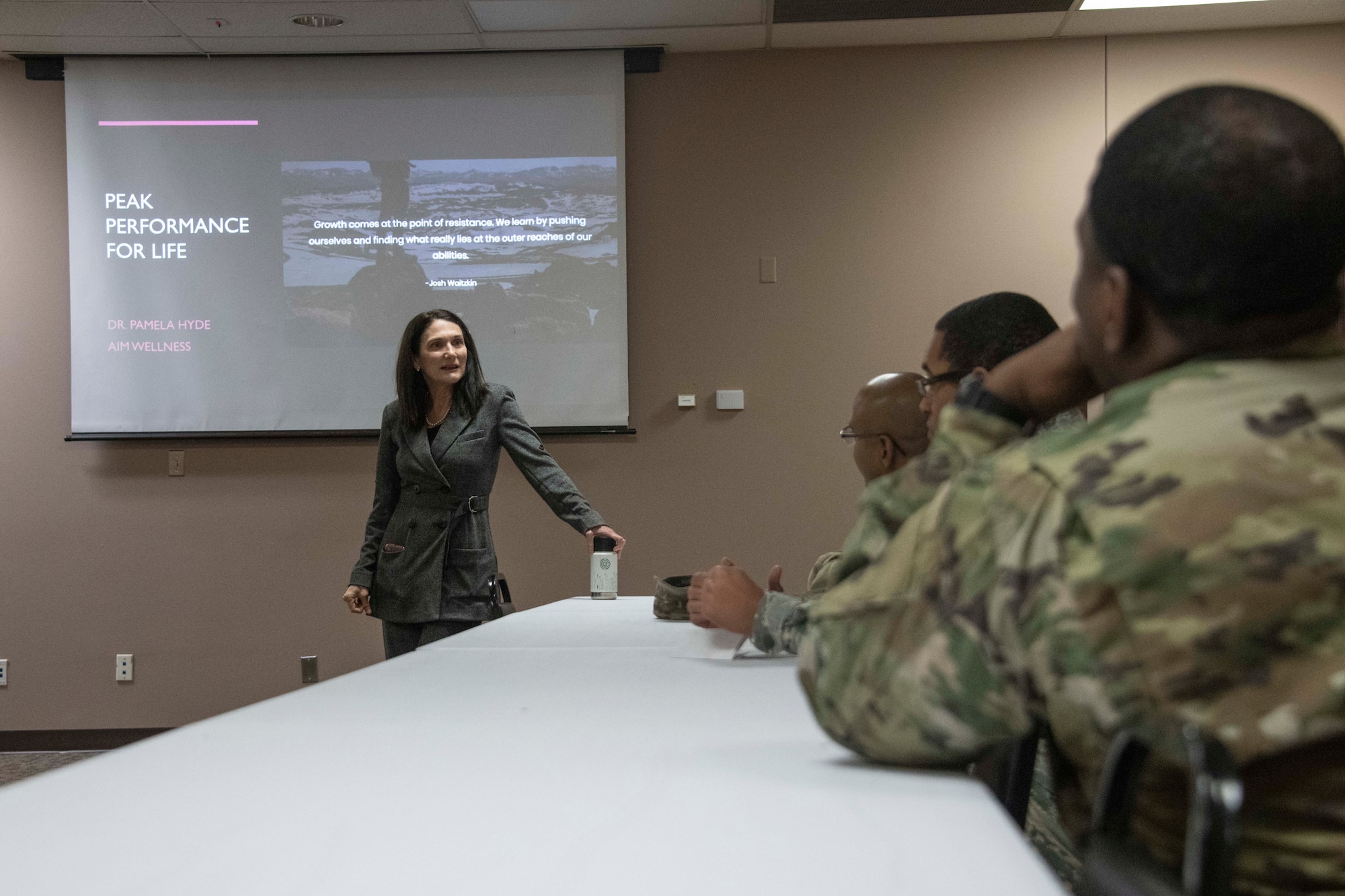 Members of the 97th Air Mobility Wing listen to Dr. Pamela Hyde, a guest speaker from Aim Wellness, during the Wellness Expo 2020