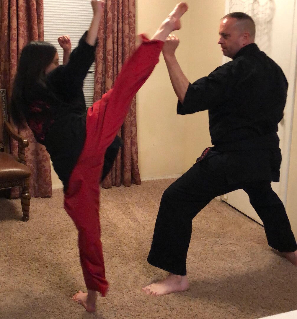 Senior Master Sgt. Scott Newberger, 161st Air Refueling Wing human resource adviser and committee member on the Diversity and Inclusion Council, practices martial arts techniques with his daughter, Jeanette, in Gilbert Ariz., December 2019.