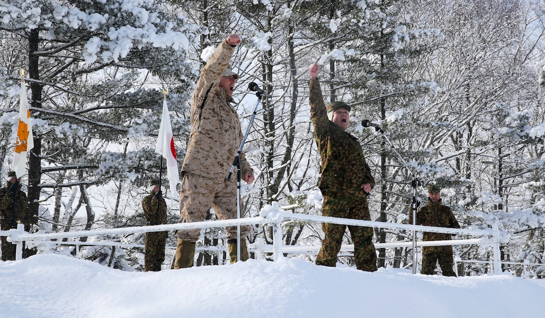 U.S. Marine and the commanding officer of 5th Brigade, Japan Ground Self-Defense Force, chant with the forces during an opening ceremony to start off exercise Northern Viper on Hokudaien Training Area, Hokkaido, Japan, Jan. 26.