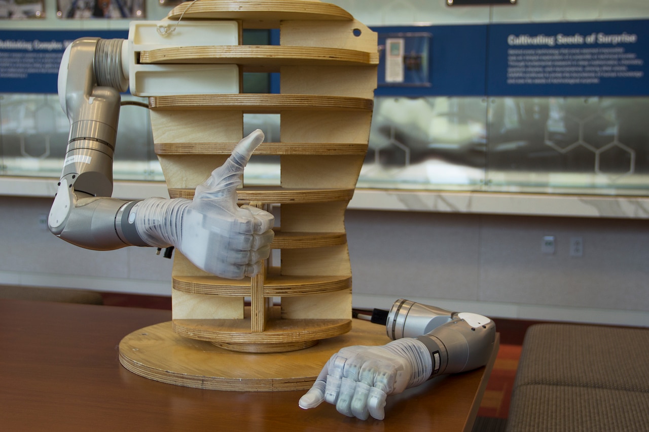 The Life Under Kinetic Evolution (LUKE) Arm™ is displayed attached to a wooden torso.
