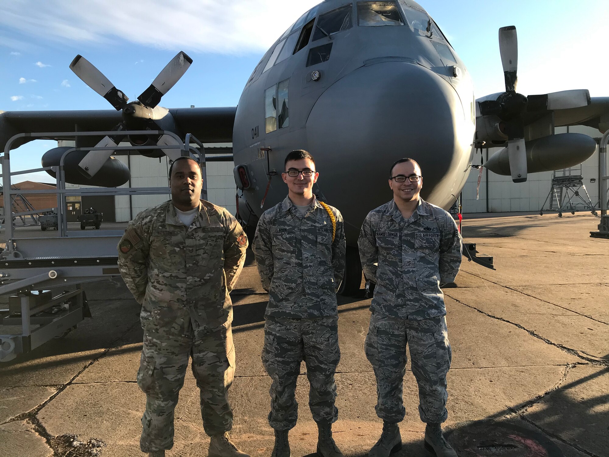 Airman Joshua Olesen, 365th Training Squadron instrument flight control systems apprentice course graduate, center, poses in front of a C-130 Hercules at Sheppard Air Force Base, Texas. (Courtesy photo)