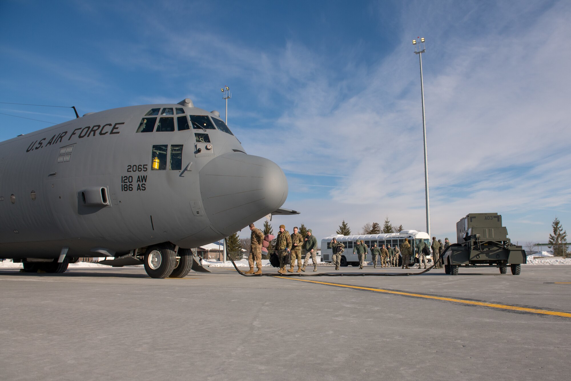 Members assigned to the 158th Fighter Wing board a C-130 assigned to the Montana Air National Guard
