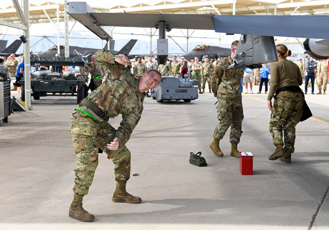 Senior Airman Robert Hepner, 310th Aircraft Maintenance Unit weapons load crew member, prepares an F-16 Fighting Falcon pylon to carry inert munitions during the Annual Load Crew Competition Jan. 24, 2020, at Luke Air Force Base, Ariz.