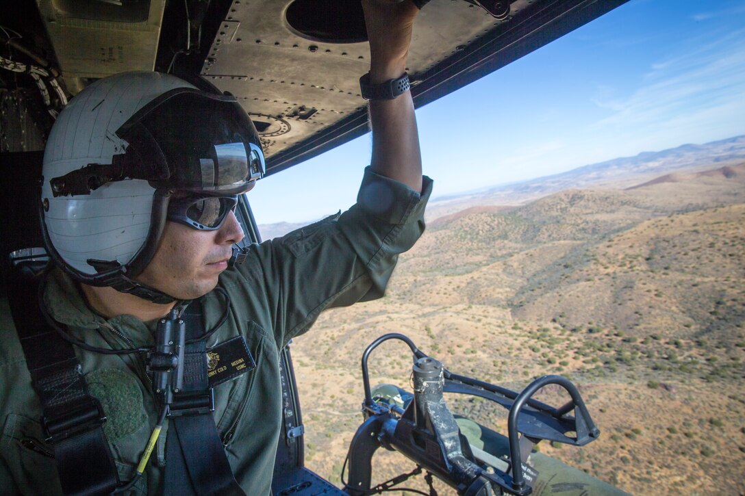 U.S. Marines with Marine Test and Evaluation Squadron (VMX) 1 conduct aerial training in a UH-1Y over the Sonoran Desert, Az., on Nov. 15, 2019. VMX-1 is an operational test squadron that tests  multiple aircraft to allow the continuation of improving the safety, reliability, and lethality of the aircraft. (U.S. Marine Corps photo by Lance Cpl John Hall)