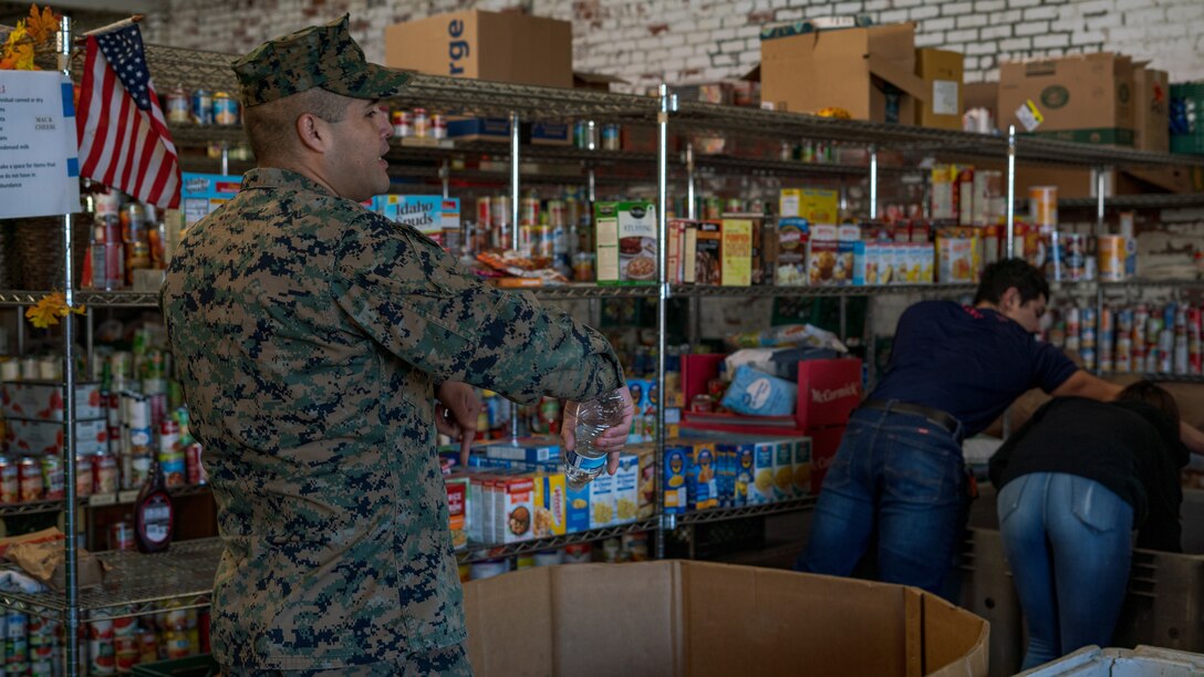 U.S Marine Corps Gunnery Sgt. Carlos Lopezmacias, a recruiter with Recruiting Substation Fresno, Recruiting Station Sacramento, gives instructions on how the warehouse needs to be organized while volunteering at the Fresno Rescue Mission in Fresno, Calif., Jan. 11, 2020. Part of the Marine Corps mission is to return quality citizens to society and this was an opportunity to give back to the community.
