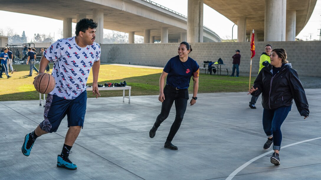 Staff members from the Fresno Rescue Mission and poolees with U.S. Marine Corps Recruiting Substation Fresno, Recruiting Station Sacramento, play a friendly game of basketball at a local community park in Fresno, Calif., Jan. 11, 2020. Part of the Marine Corps mission is to return quality citizens to society and this was an opportunity to give back to the community.