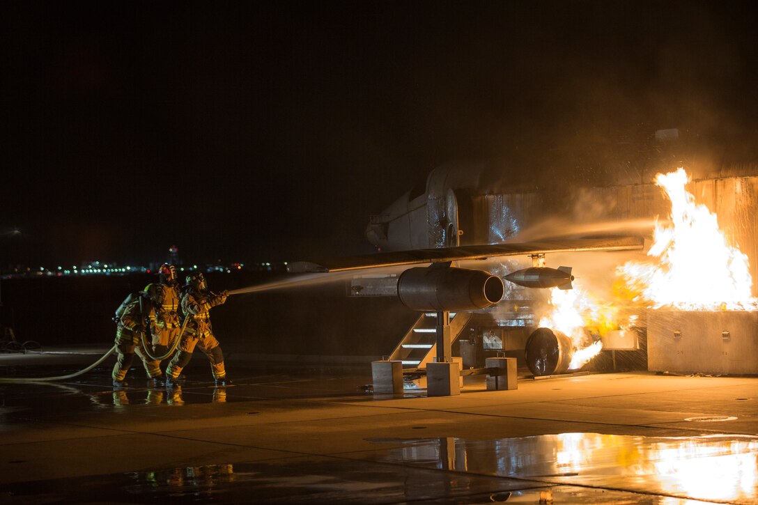 U.S. Marines with Aircraft Rescue and Firefighting (ARFF), Headquarters and Headquarters Squadron (H&HS), Marine Corps Air Station (MCAS) Yuma conduct low light hand line drills during live burn training on MCAS Yuma, Ariz., Nov. 21, 2019.