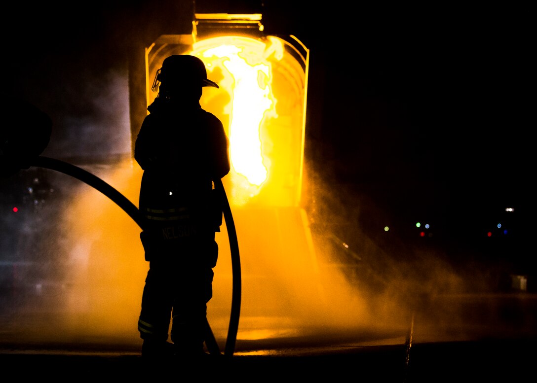 U.S. Marines with Aircraft Rescue and Firefighting (ARFF), Headquarters and Headquarters Squadron (H&HS), Marine Corps Air Station (MCAS) Yuma conduct low light hand line drills during live burn training on MCAS Yuma, Ariz., Nov. 21, 2019.