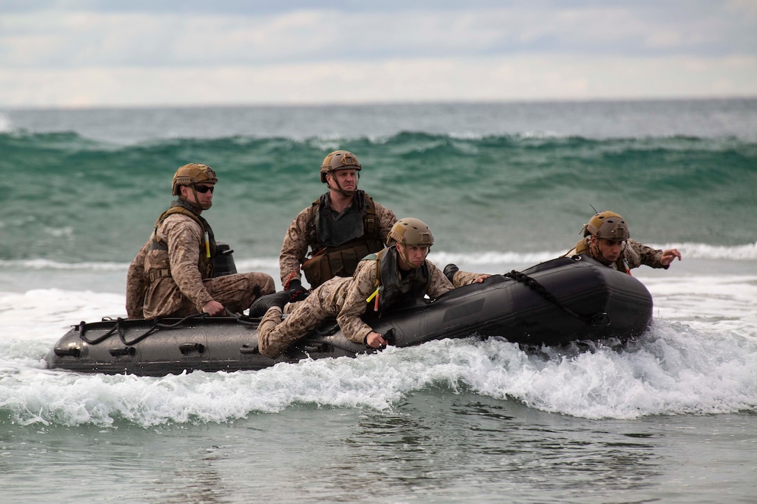 Marines travel through waters in an inflatable boat.