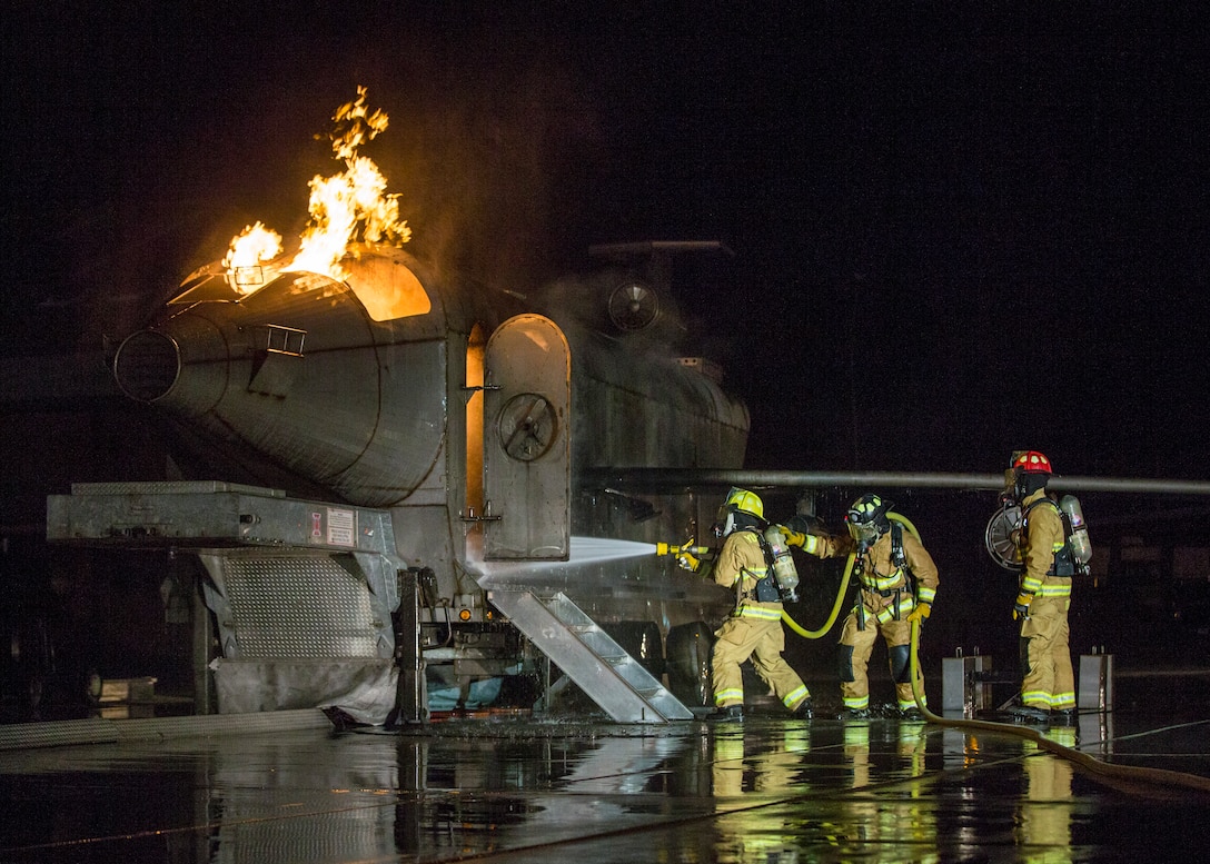 U.S. Marines with Aircraft Rescue and Firefighting (ARFF), Headquarters and Headquarters Squadron (H&HS), Marine Corps Air Station (MCAS) Yuma conduct low light hand line drills during live burn training on MCAS Yuma, Ariz., Nov. 21, 2019.