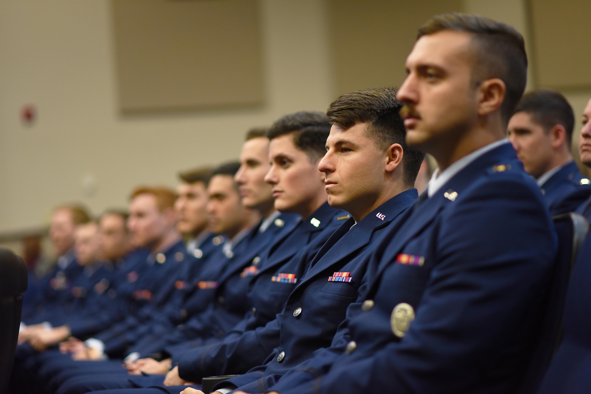 Specialized Undergraduate Pilot Training Class 20-06/07 sit in the Kaye Auditorium during their graduation ceremony Jan. 24, 2020, on Columbus Air Force Base, Mississippi. The graduating pilots will each depart to their new respective bases to fly aircraft such as the F-16 Fighting Falcon, C-17 Globemaster III, F-35 Lightning II, KC-135 Stratotanker, and more while some stay at Columbus to become First Assignment Instructor Pilots. (U.S. Air Force photo by Senior Airman Keith Holcomb)