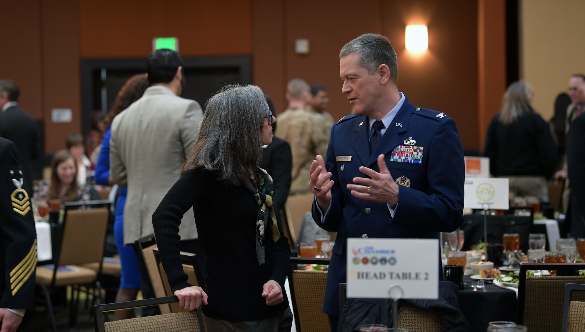 Col. Aras Suziedelis, National Security Agency-Colorado deputy director, speaks with Andrea Grayson, an event attendee, during the annual State of the Base luncheon at the Radisson Hotel in Aurora, Co., Jan. 22, 2020.