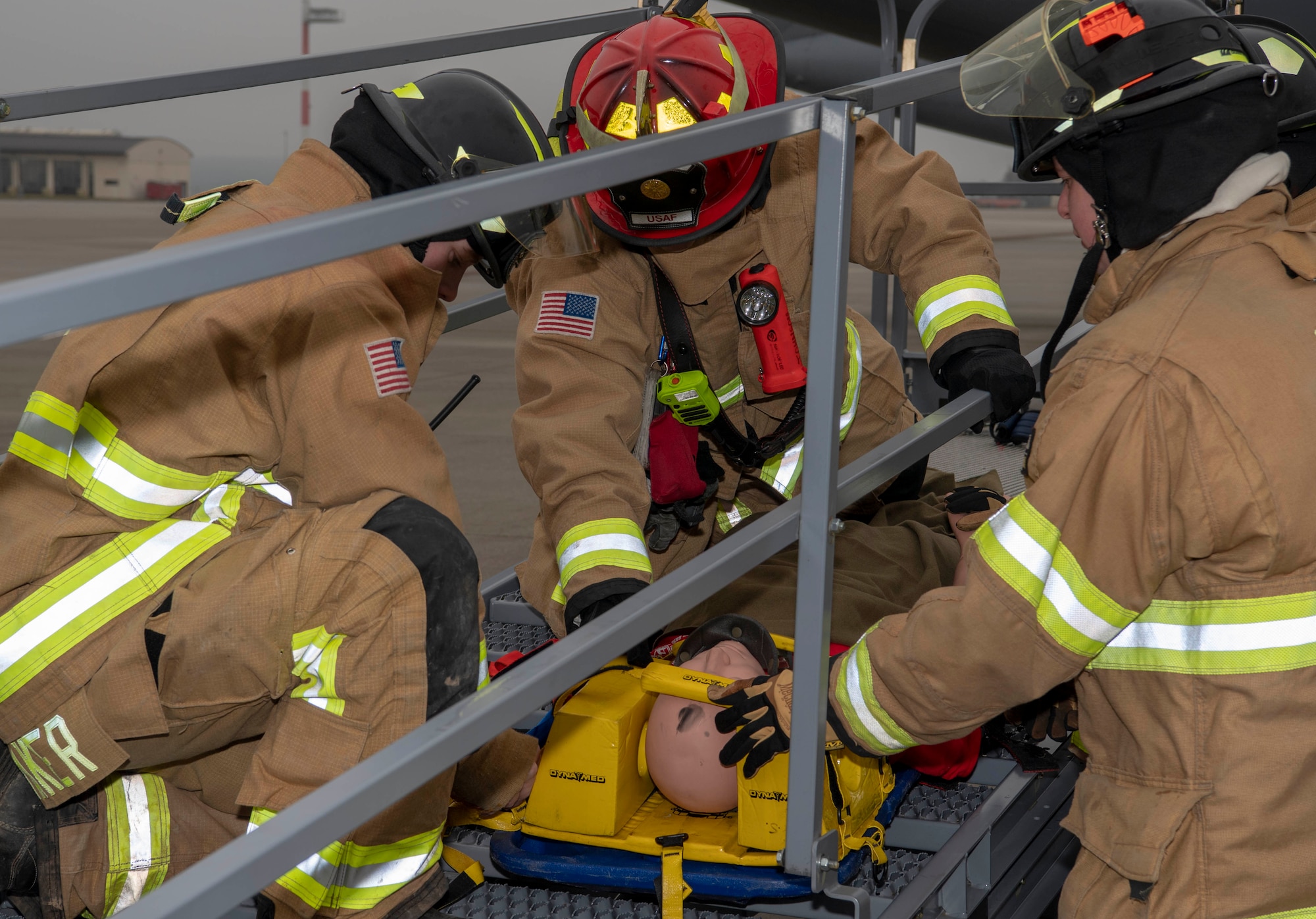 U.S. Air Force firefighters from the 52nd Civil Engineer Squadron secure a dummy to a backboard during a fall protection exercise at Spangdahlem Air Base, Germany, Jan. 23, 2020. The firefighters partnered with the 726th Air Mobility Squadron to perform the training exercise. (U.S. Air Force photo by Senior Airman Kyle Cope)