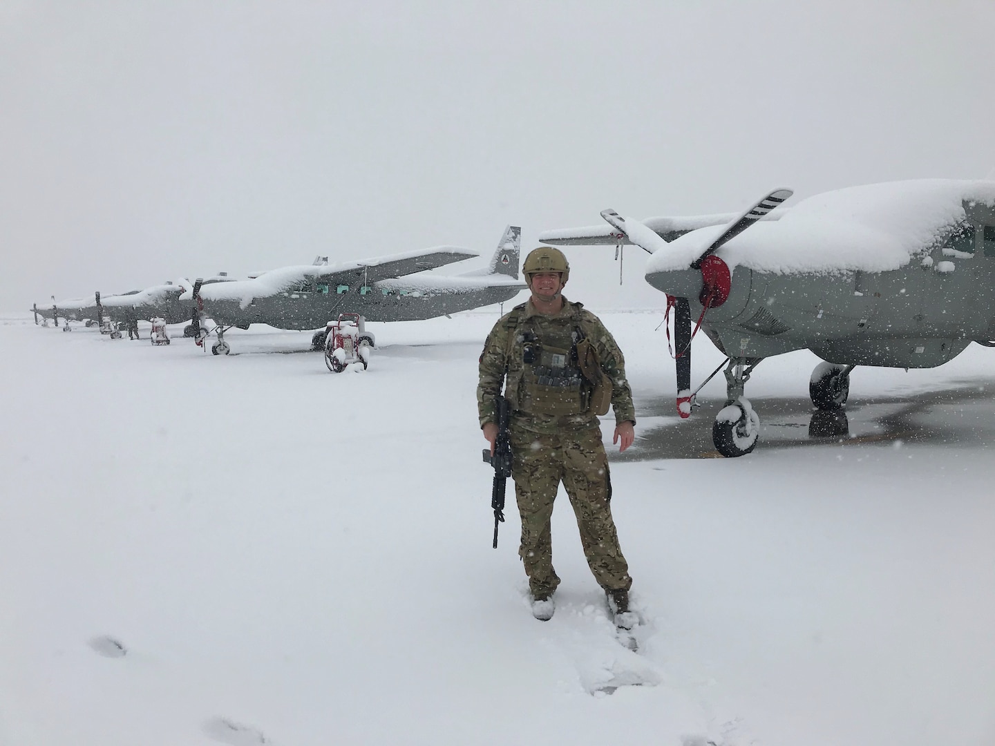U.S. Air Force Lt. Col. Carl Miller, 538th Air Expeditionary Advisory Squadron commander, stands next to Afghan air force C-208 Caravans on the flightline at Hamid Karzai International Airport in Kabul, Afghanistan in January 2019.  While deployed, Miller advised the entire AAF Kabul Wing operations group, including six major weapons systems, 86 aircraft, six squadrons and 201 aircrew members, helping earn him a 2019 Air Force Lance P. Sijan Leadership Award. (Courtesy Photo)